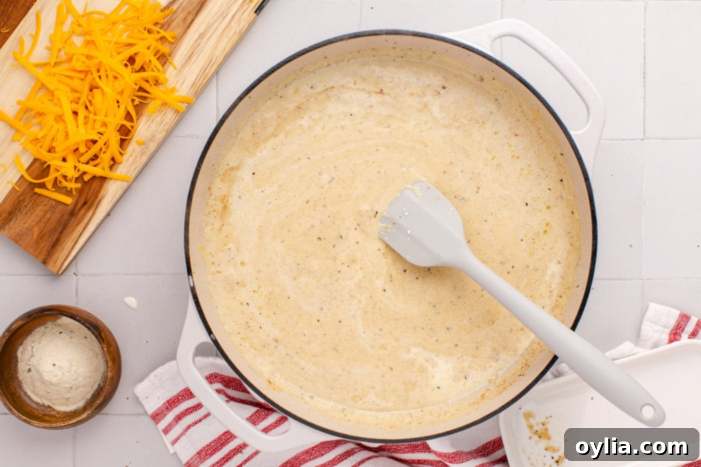 rubber spatula in pan of creamy ranch sauce, showing smooth texture