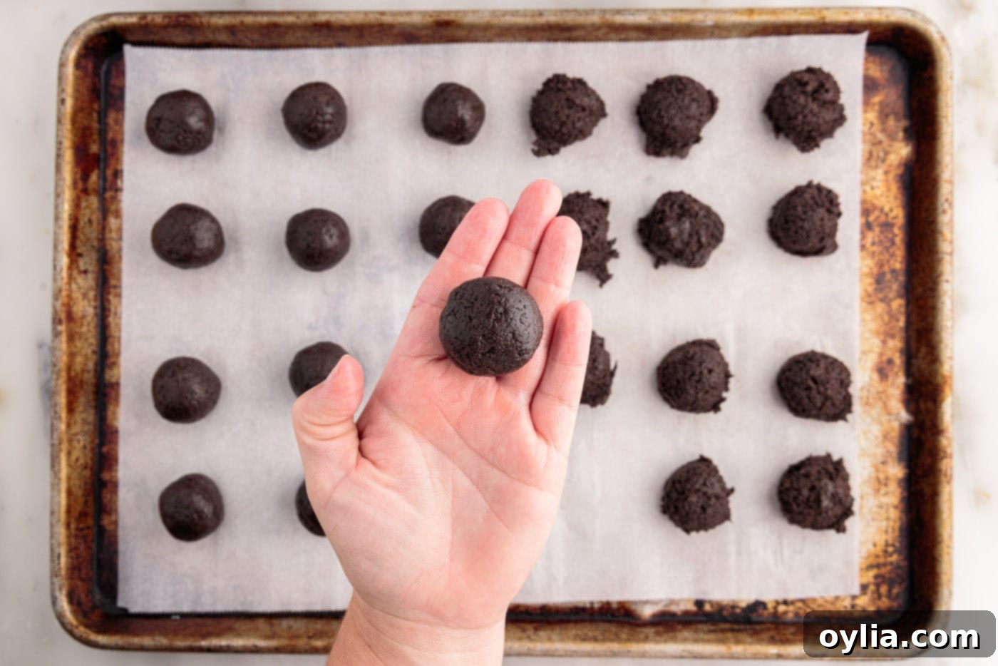 Rolling the Oreo mixture into perfectly smooth balls.