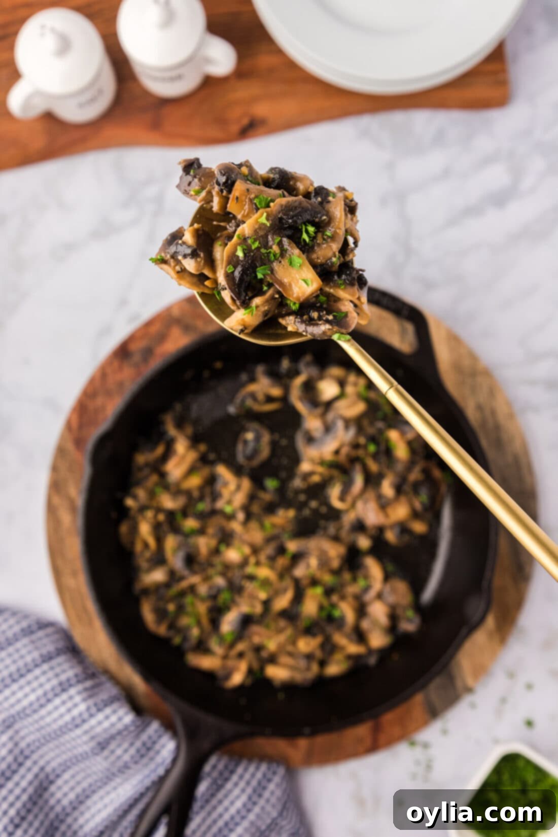 Savory Skillet Mushrooms 2 Spoonful of Sautéed Mushrooms held over a skillet