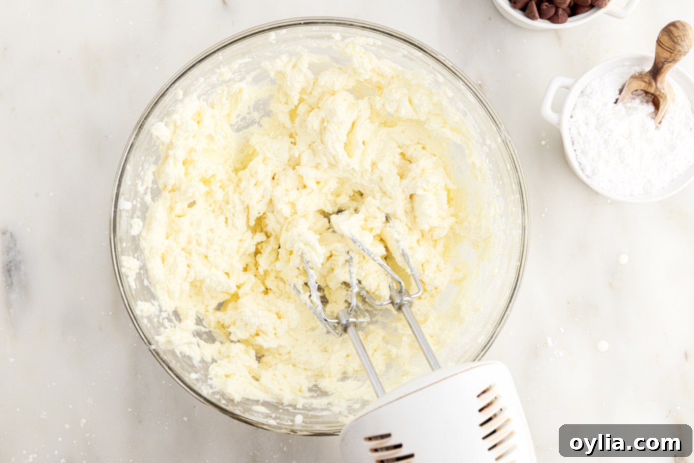 beating buttercream with a hand mixer until light and fluffy