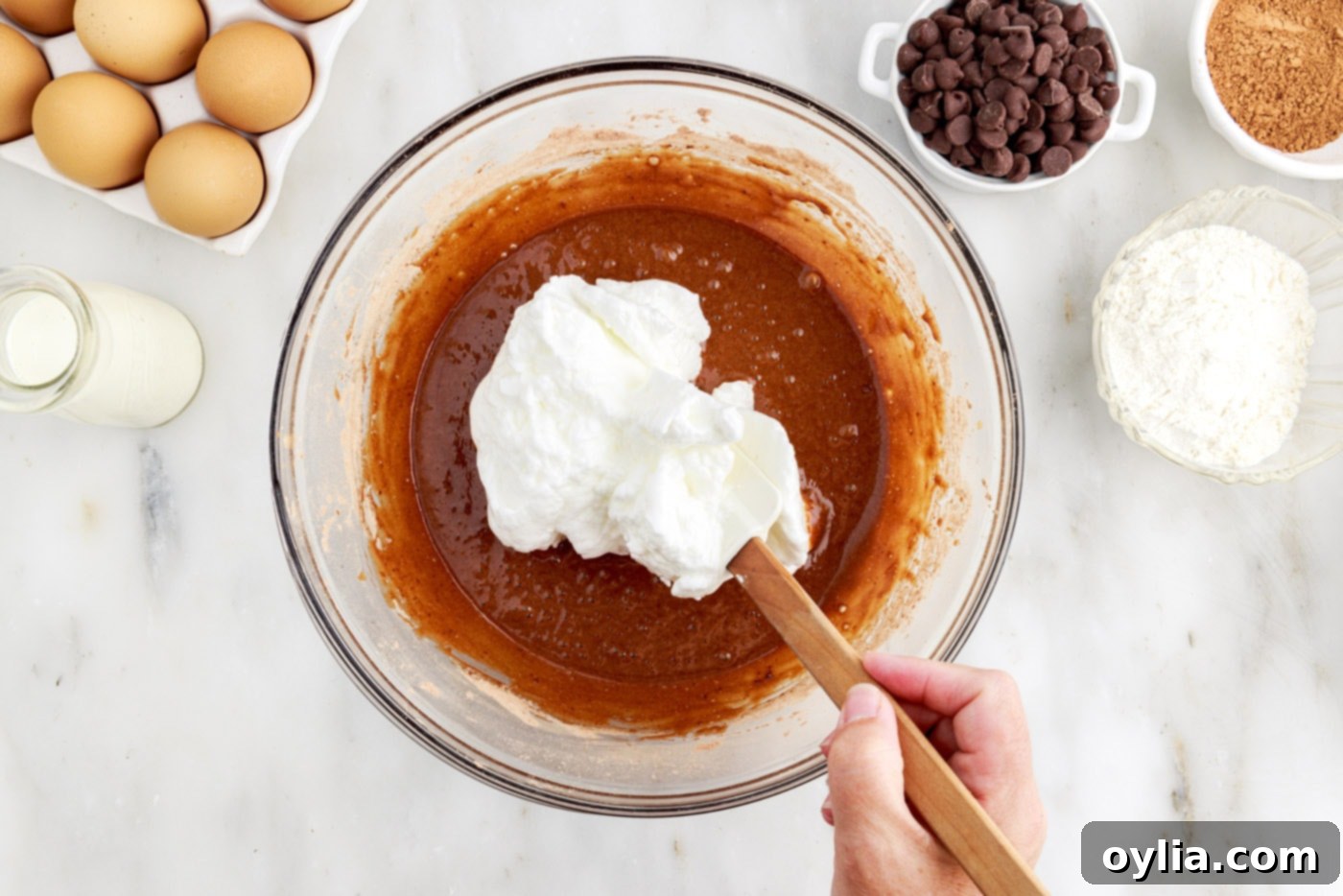 folding egg white mixture into chocolate cake batter using a spatula