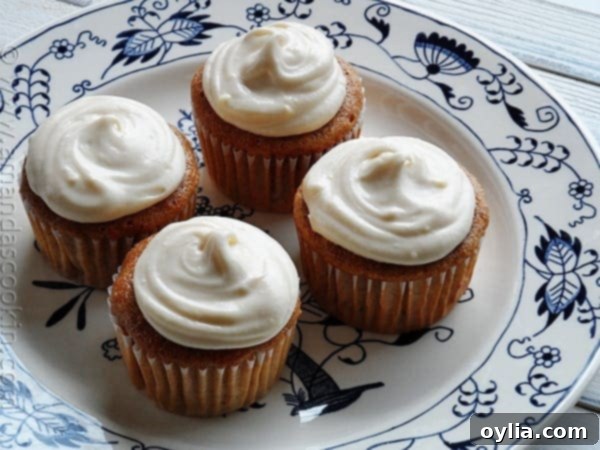 Delicious time-saver carrot cupcakes with cream cheese frosting, served on a plate.