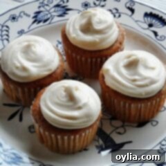 Quick Carrot Cupcakes 8 A trio of frosted carrot cupcakes with cream cheese, showcasing their homemade appeal.