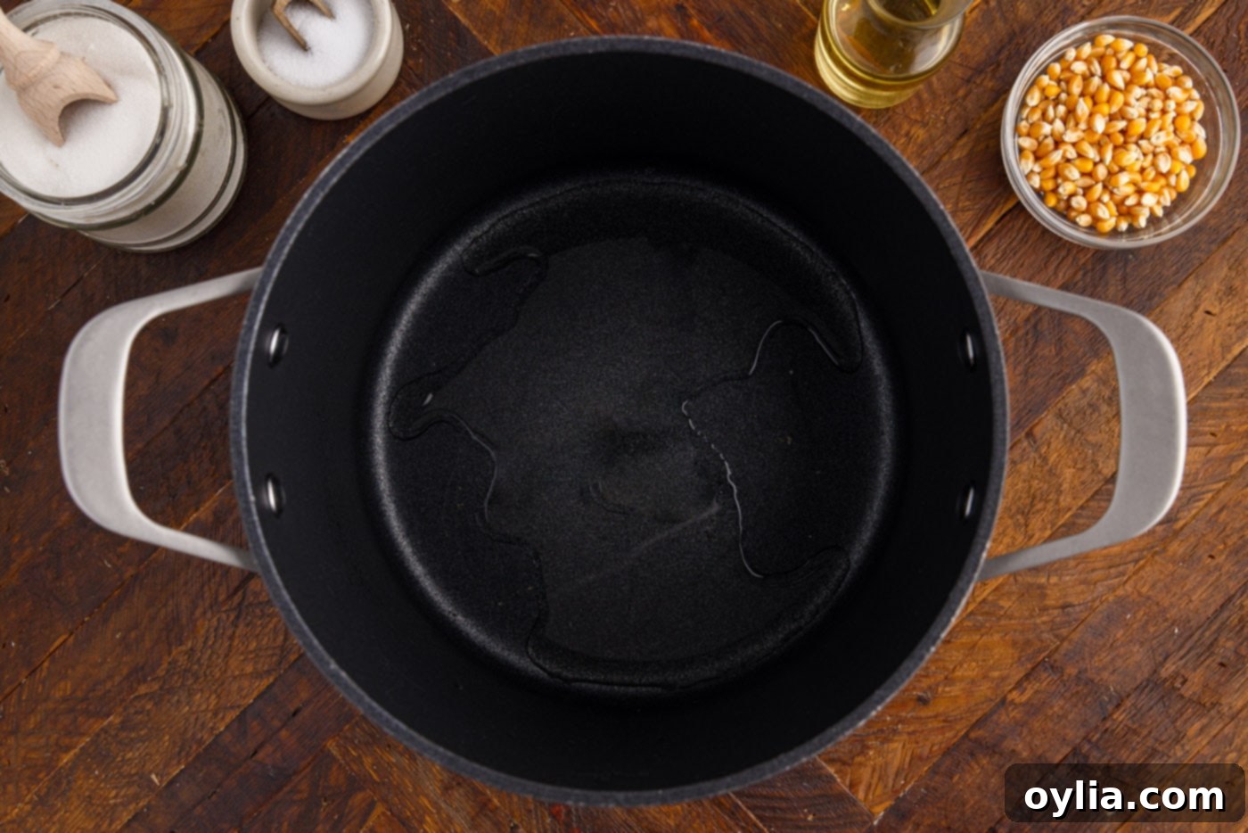 Vegetable oil glistening in a pot, ready for popcorn kernels.