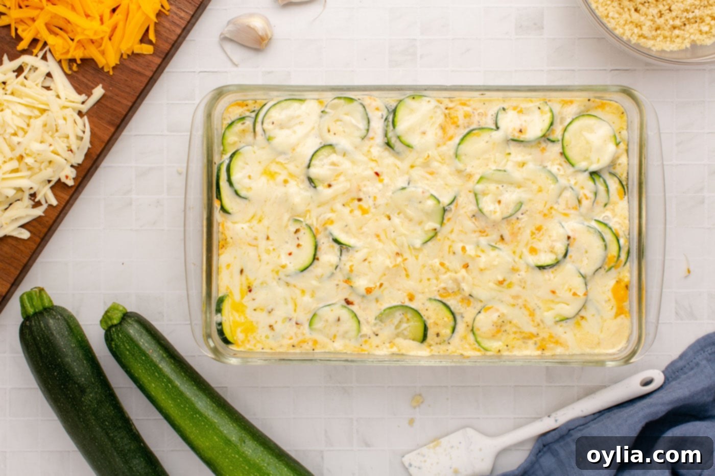 Covered zucchini casserole baking in the oven until bubbly and hot.