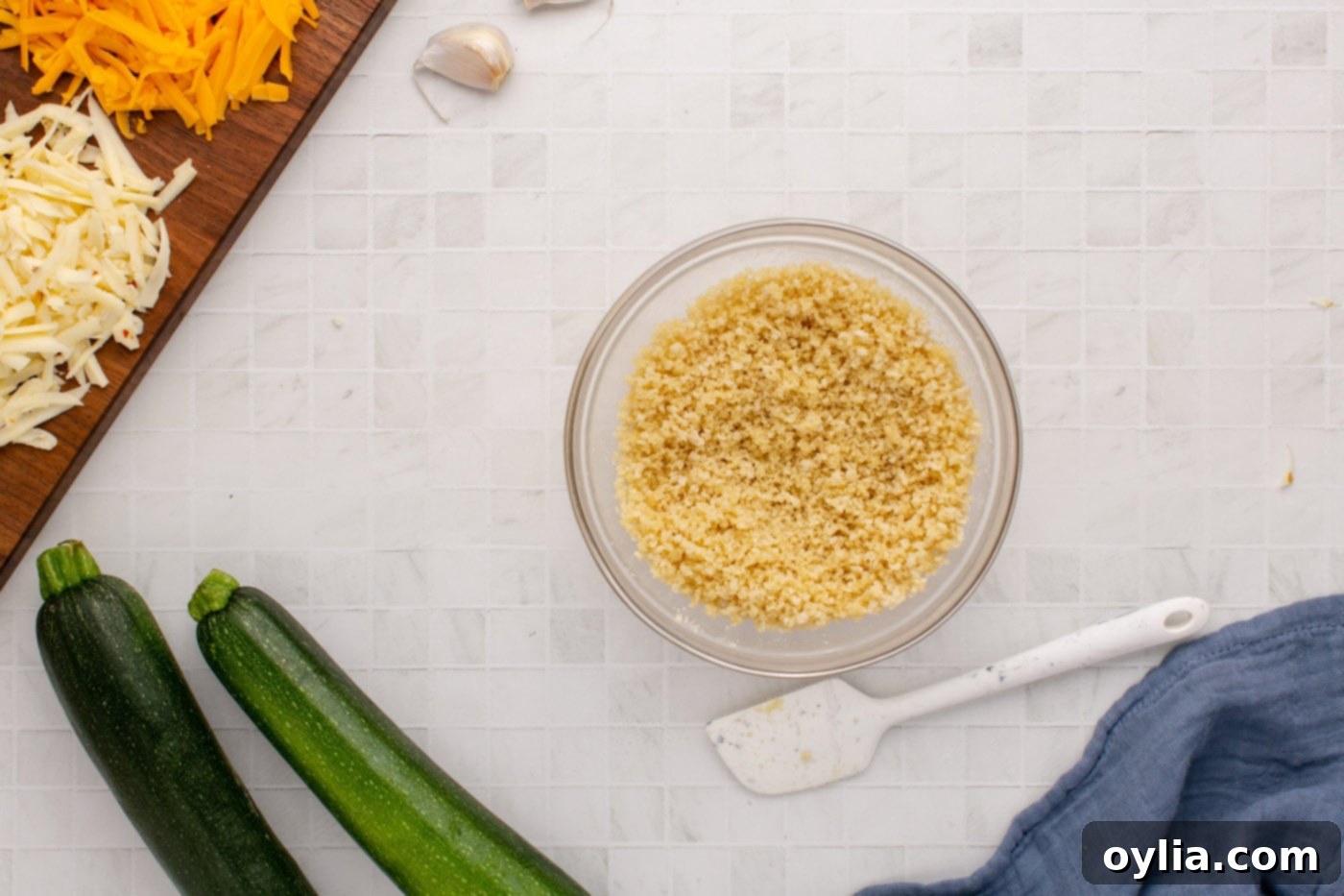 Panko breadcrumbs being mixed with melted butter in a small bowl for the crispy topping.