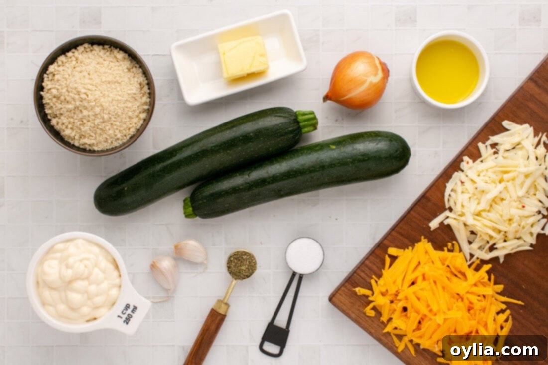 Fresh ingredients laid out for Zucchini Casserole, including sliced zucchini, cheeses, onion, garlic, and mayonnaise.