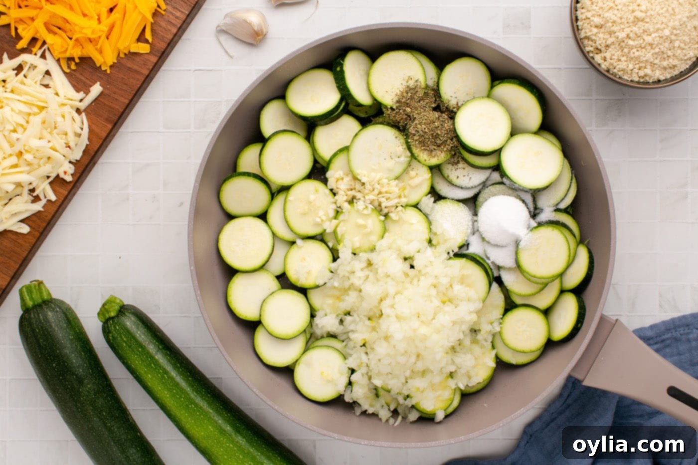 Sliced zucchini, chopped onion, minced garlic, and Italian seasoning sautéing in a large skillet until tender.