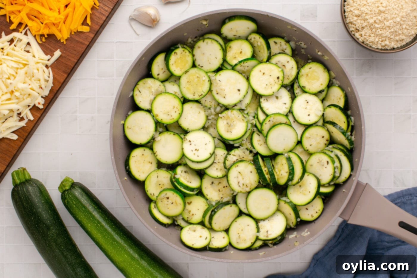 Close-up of golden brown, lightly sautéed zucchini slices in a skillet.