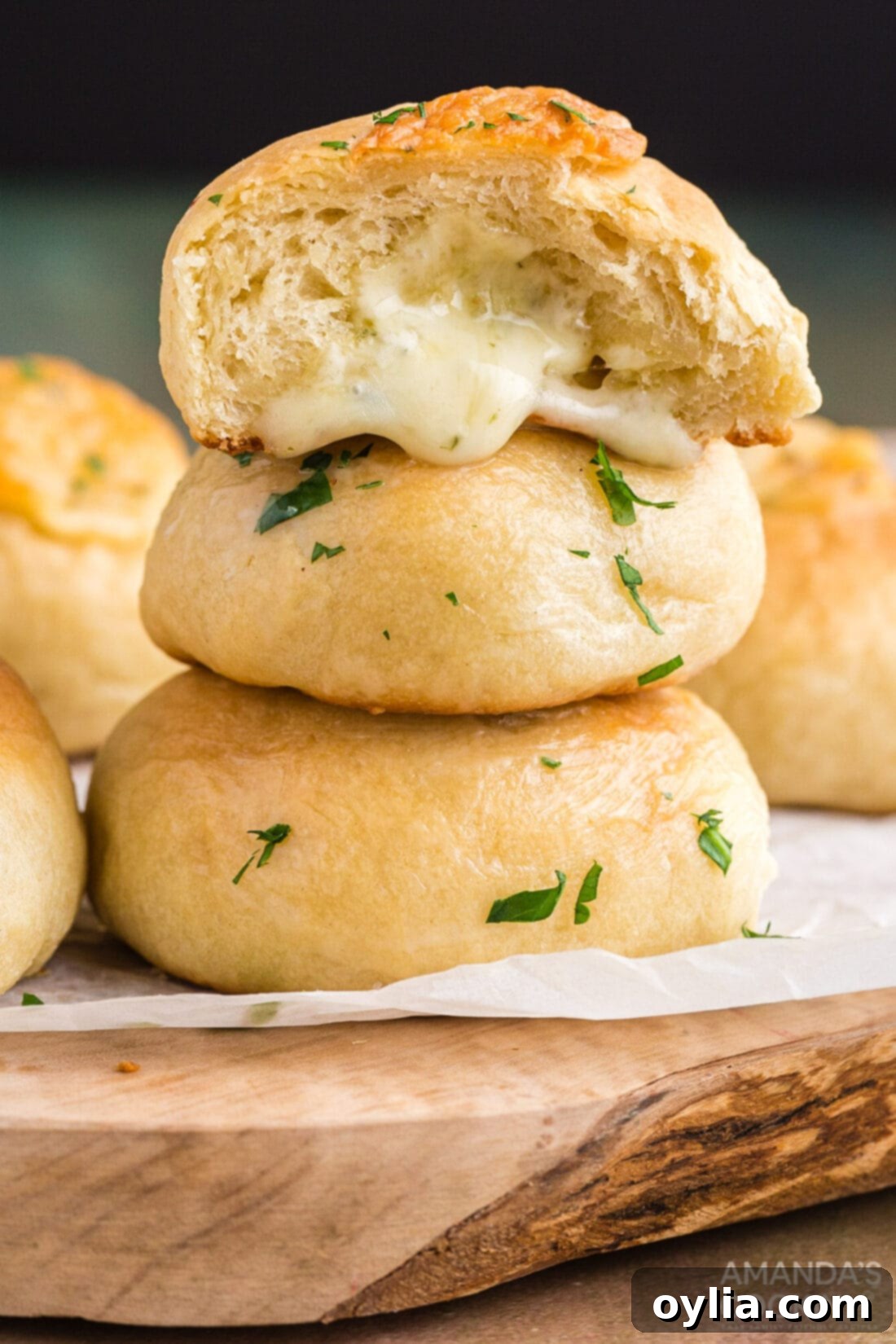Golden Garlic Cheese Rolls 2 cheese rolls stacked on a cutting board, golden brown and inviting