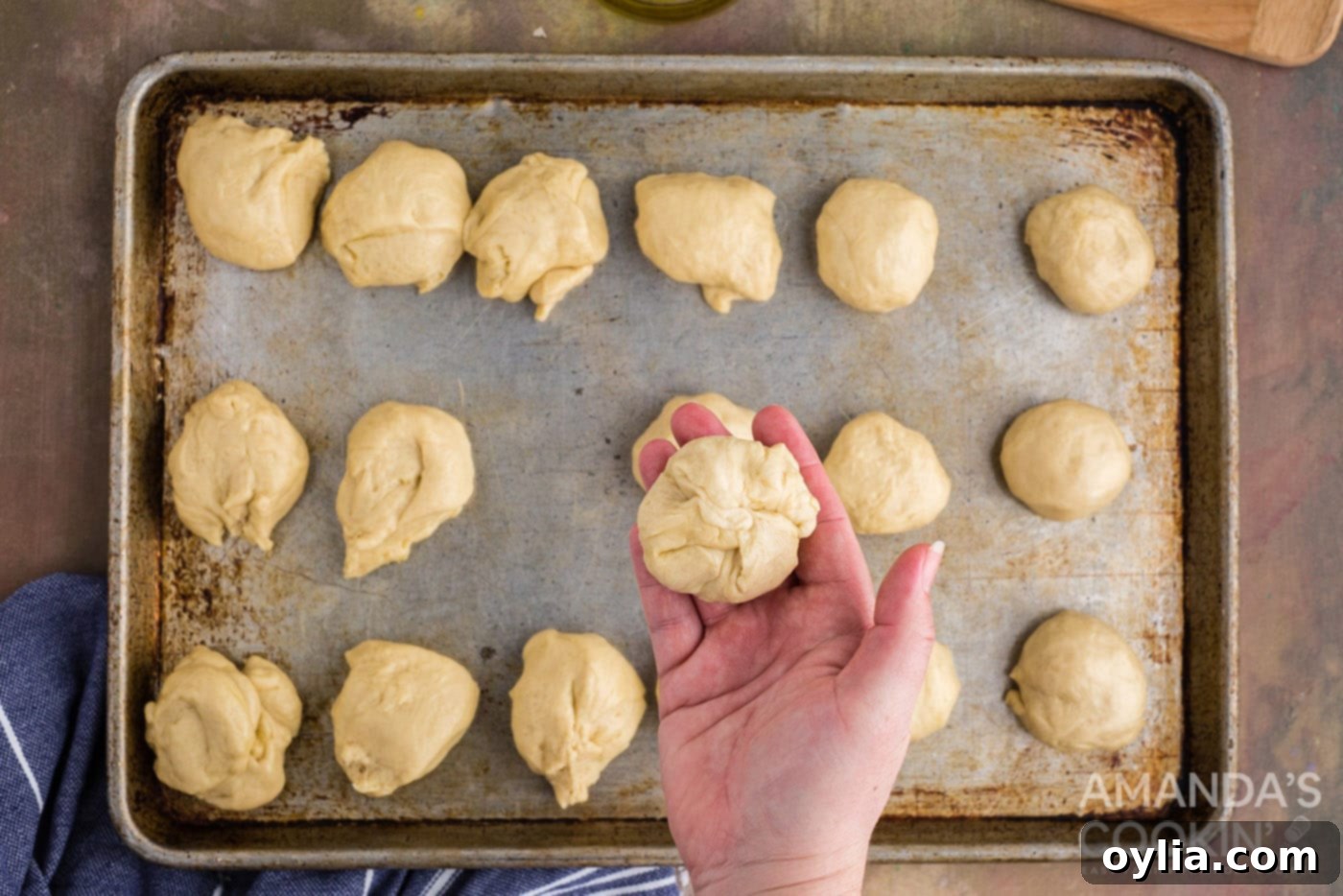 Golden Garlic Cheese Rolls 11 pinched dough ball with cheese inside in a hand