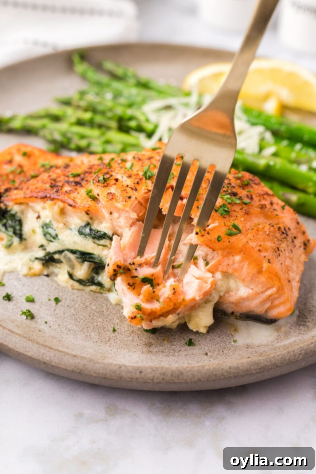 Exquisite Stuffed Salmon 21 Fork breaking a piece of Stuffed Salmon off the filet