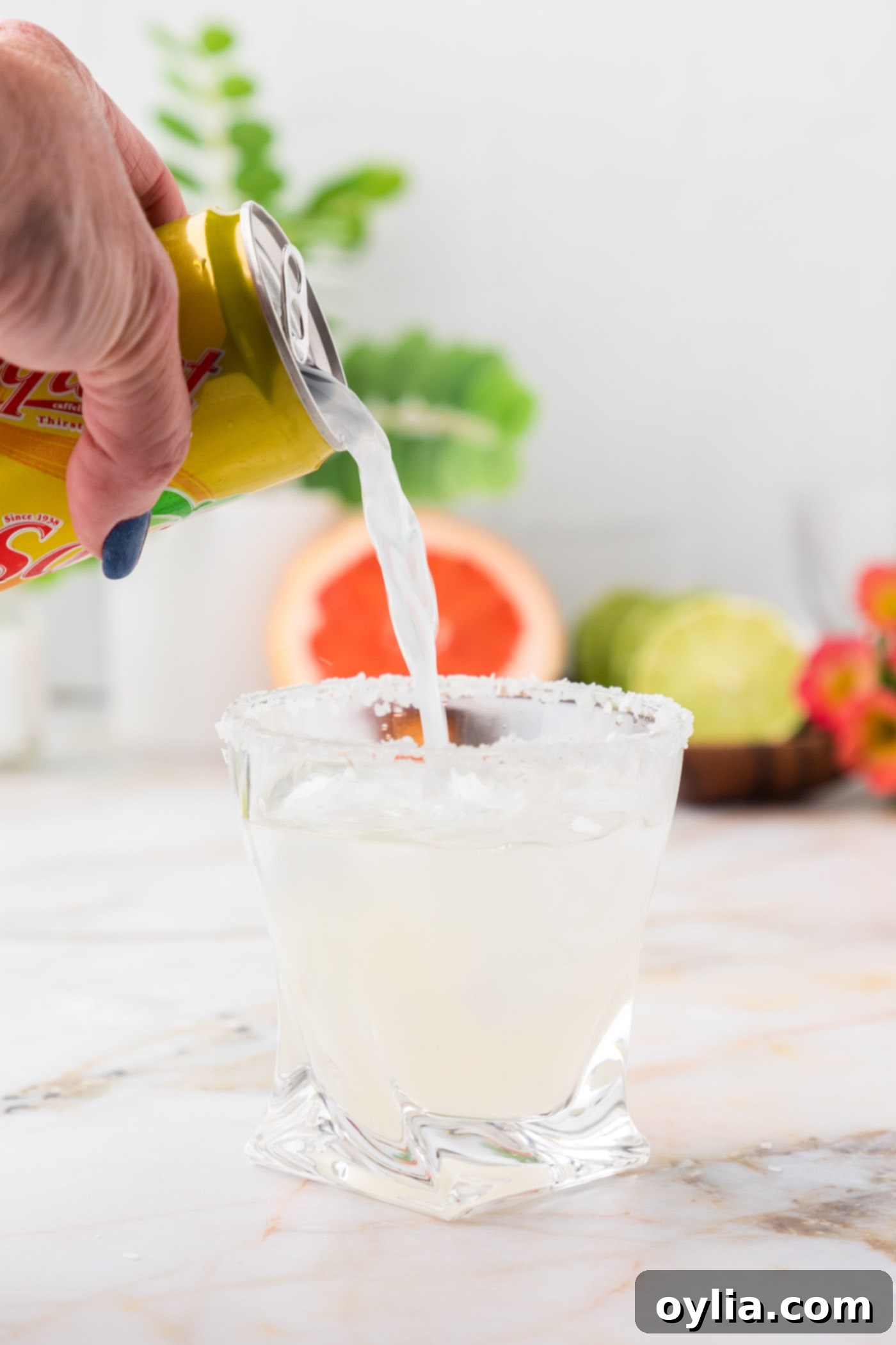 adding grapefruit soda to lime juice and tequila