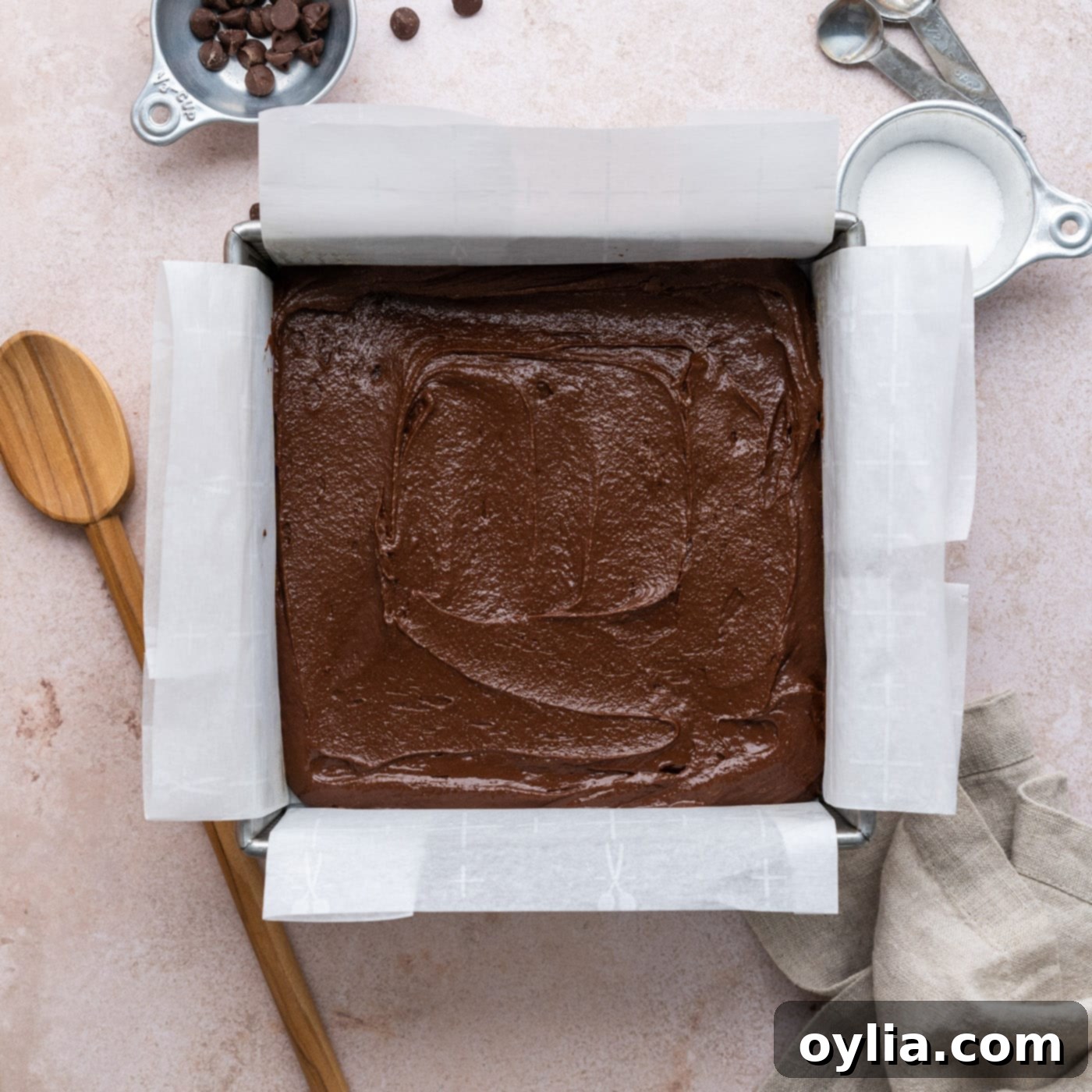 brownie batter spread evenly in a baking pan