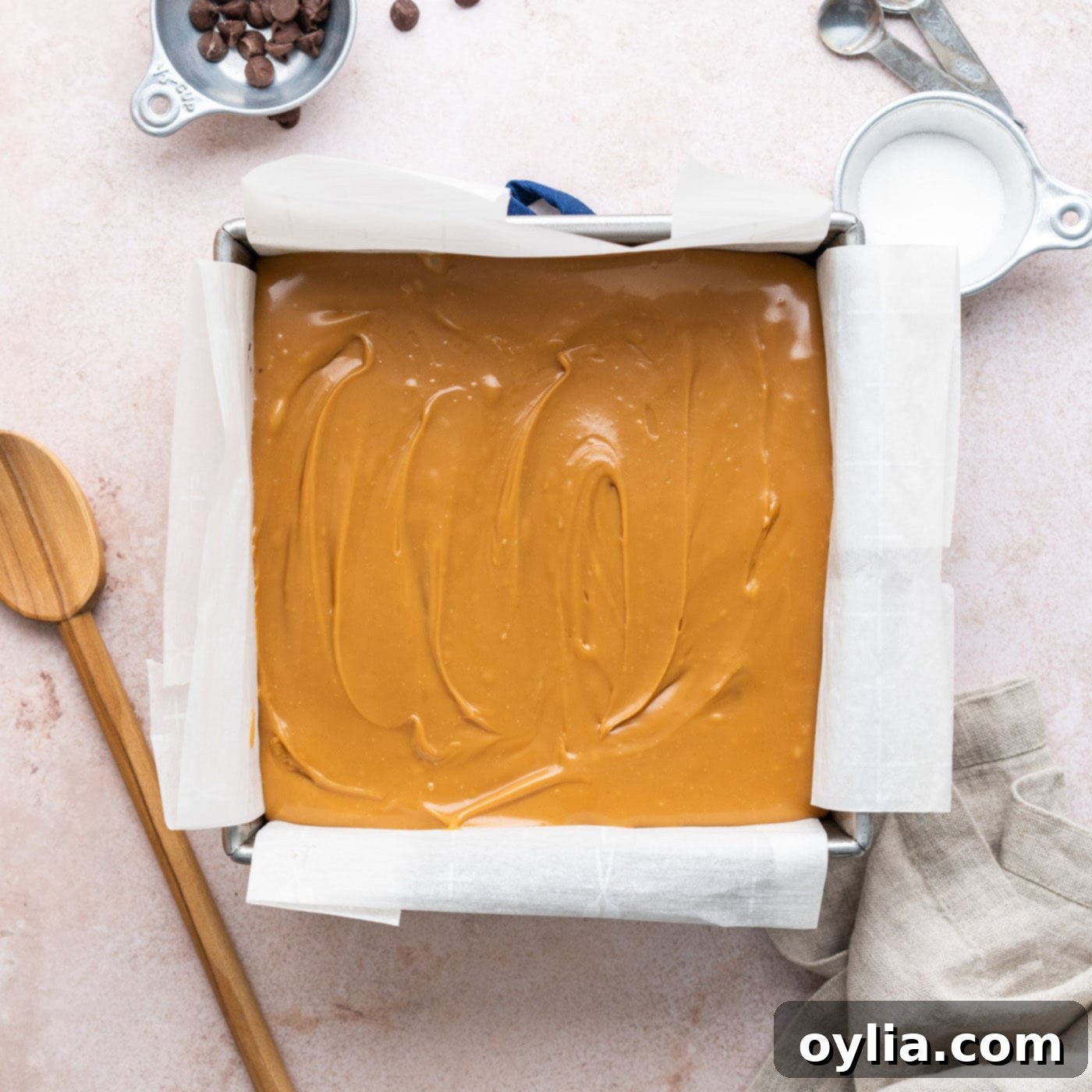 layer of warm caramel poured over cooled brownies in a pan