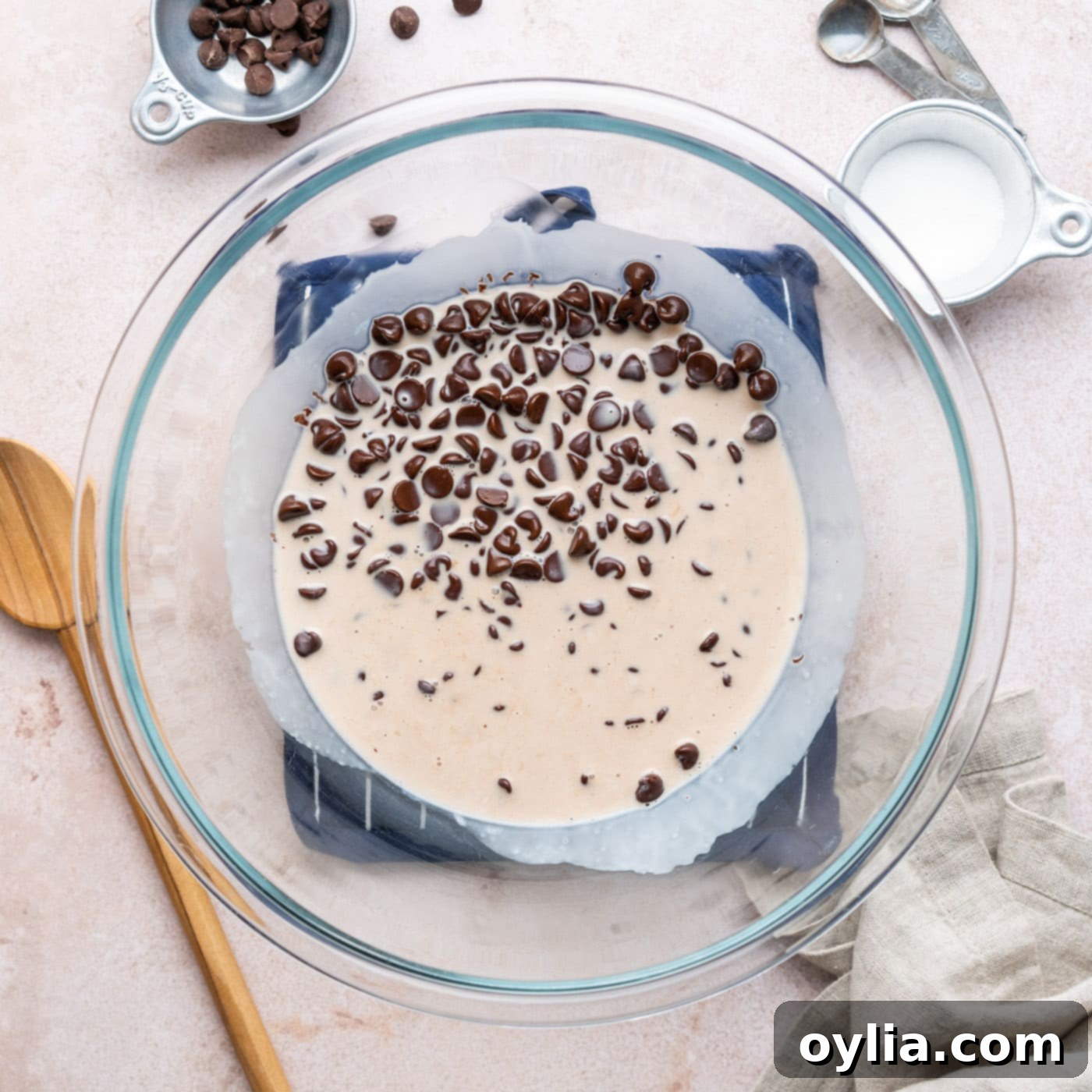 chocolate chips in a bowl with heavy whipping cream before heating for ganache