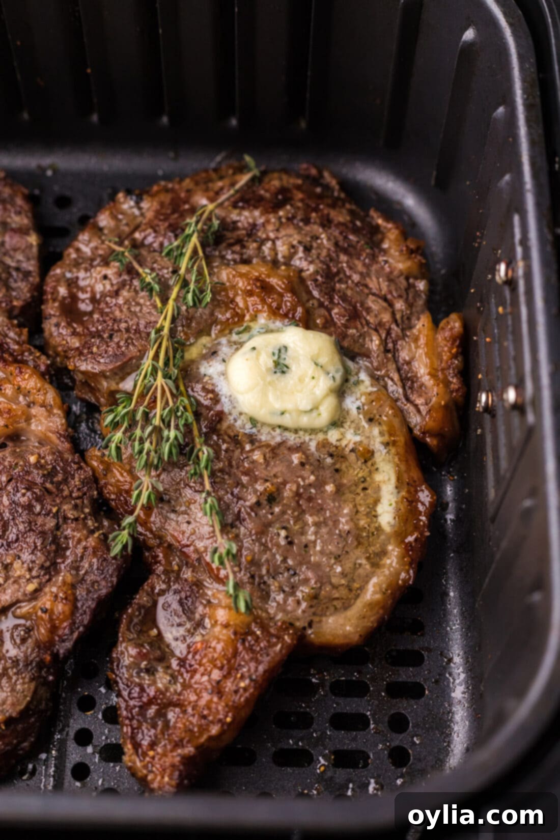 Air Fried Steak Perfection 8 Close-up photo of a beautifully seared Air Fryer Steak in an air fryer basket, with a perfectly brown crust.
