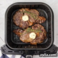 Air Fried Steak Perfection 9 Two Air Fryer Steaks in an Air Fryer topped with butter