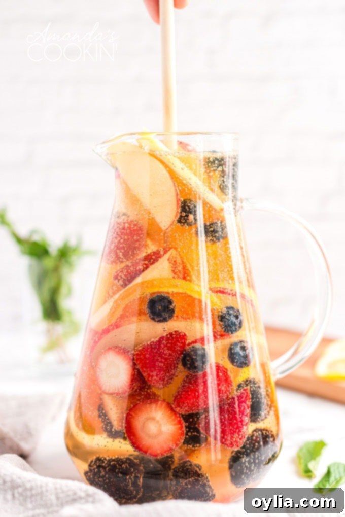 pitcher filled with white sangria and colorful fresh fruit