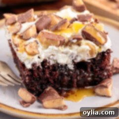 Piece of Better Than Sex Cake on a plate with a fork, ready to be enjoyed.