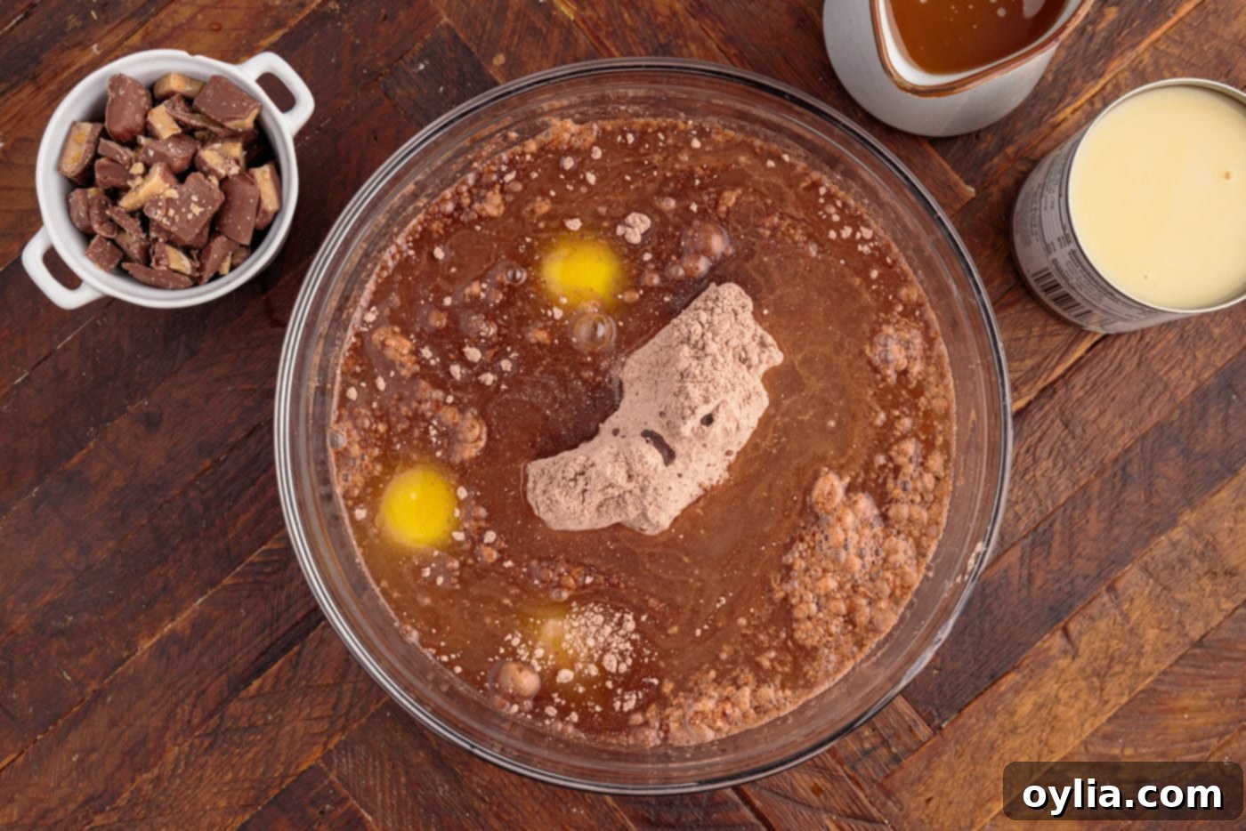 Mixing eggs, oil, water, and cake mix in a large bowl with an electric mixer.
