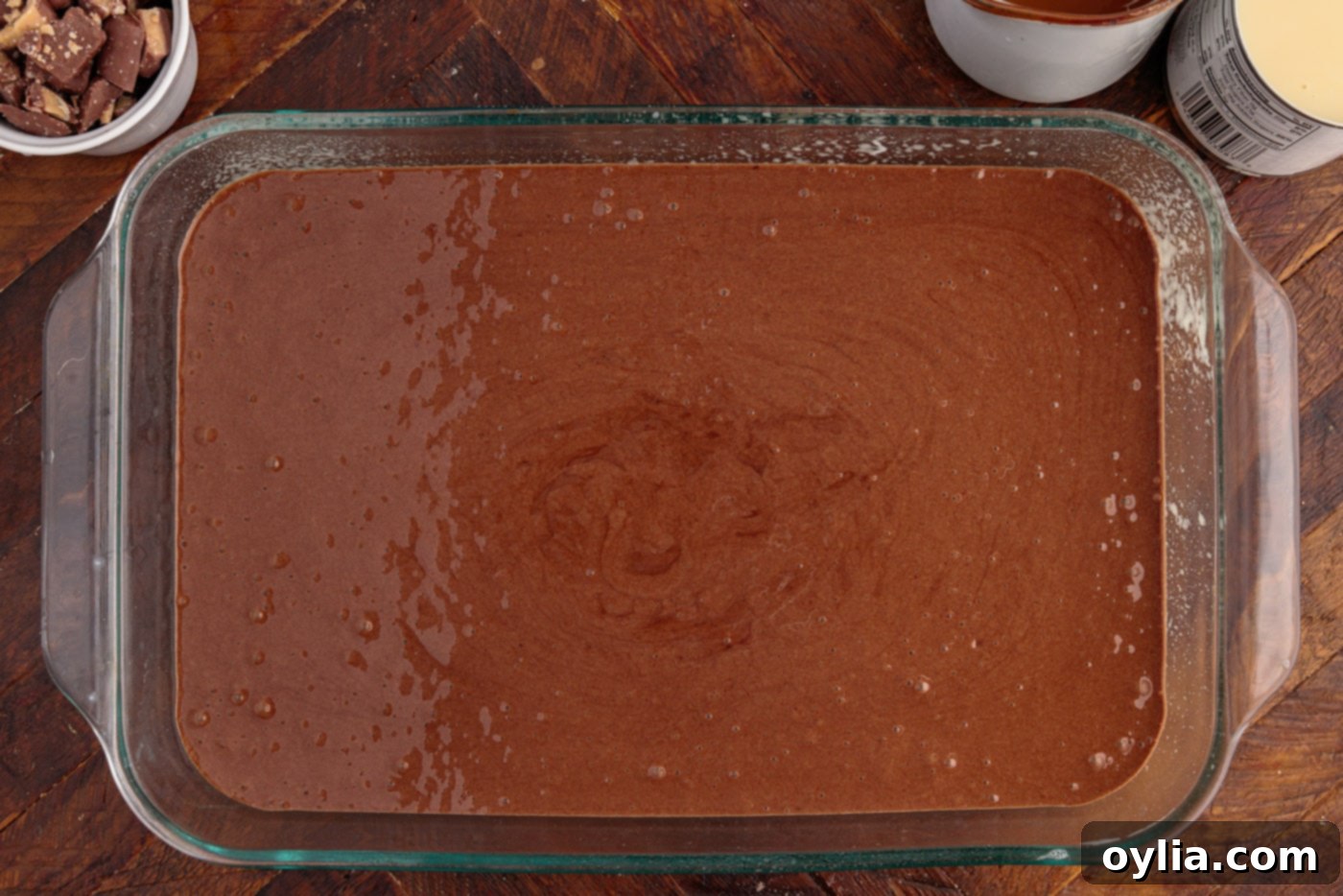 Devils food cake batter poured into a 13x9 inch baking dish, ready for the oven.