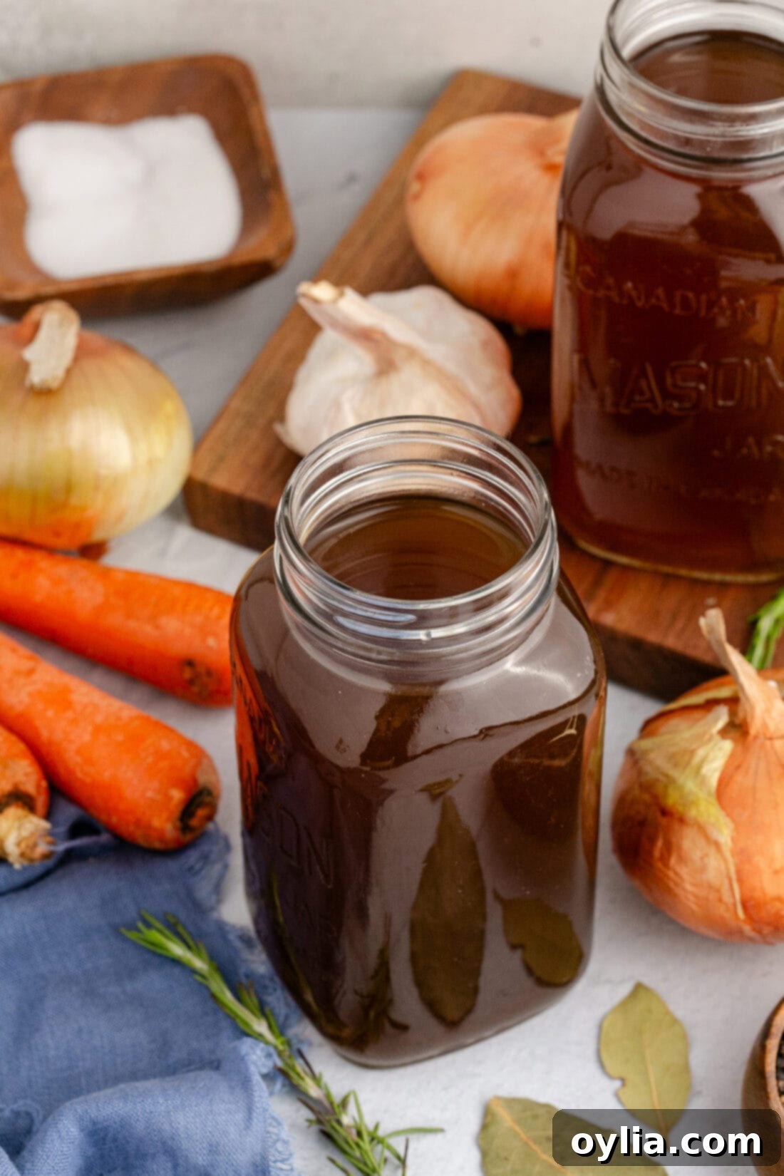 Jar of Vegetable Broth with vegetables in the background