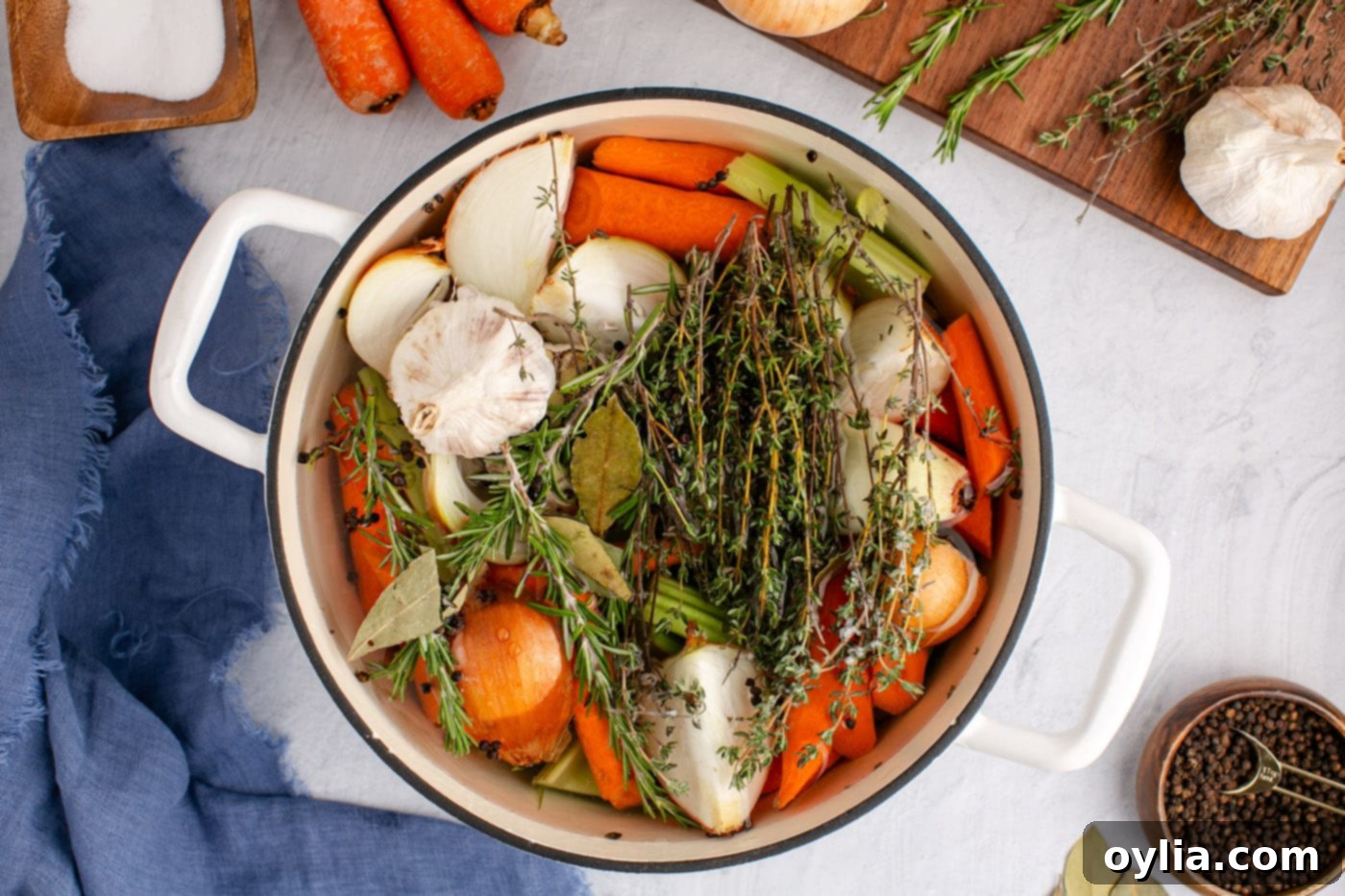 adding water to vegetables and herbs in a stockpot