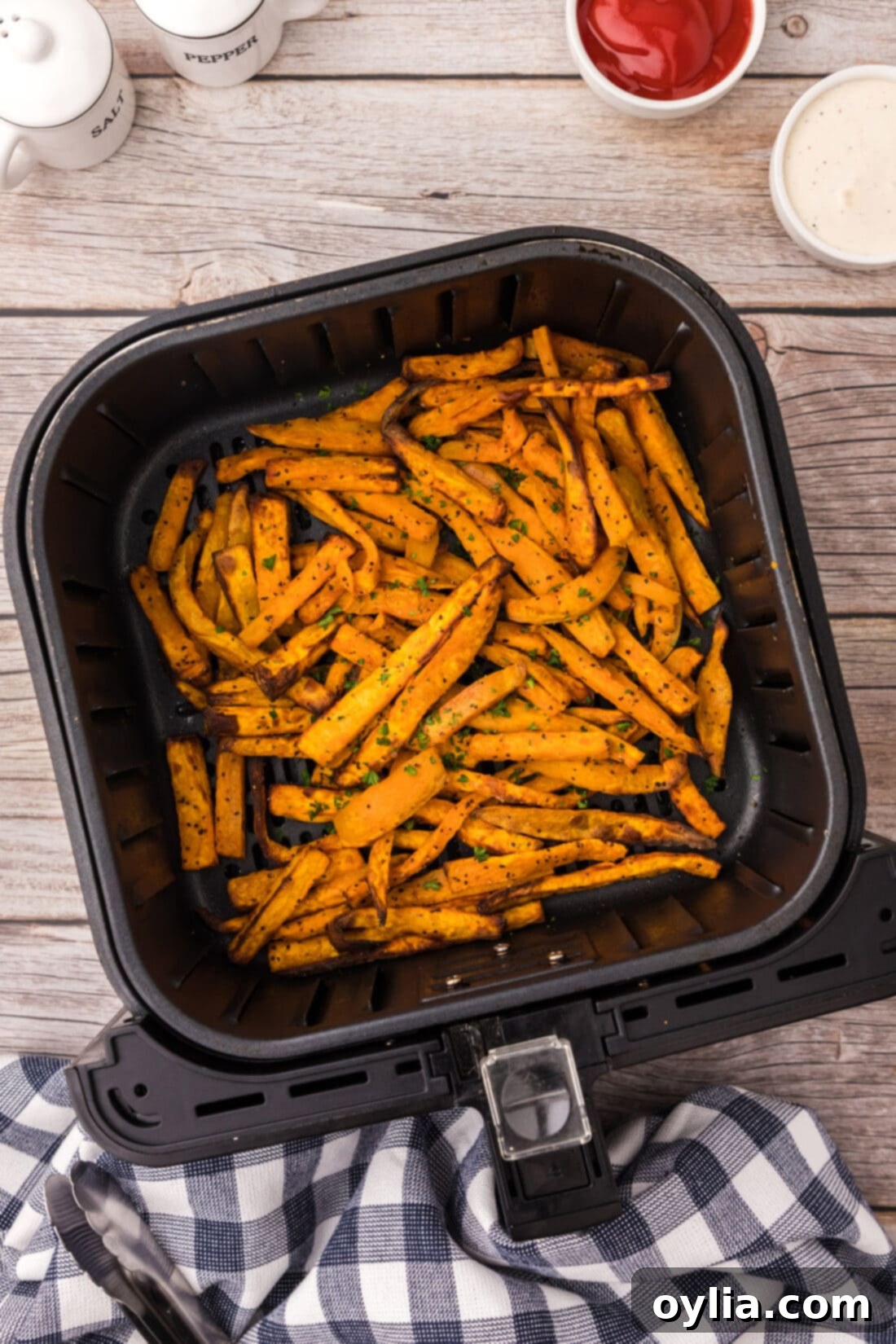 Air Fryer Sweet Potato Fries in an air fryer basket, perfectly golden and crispy.