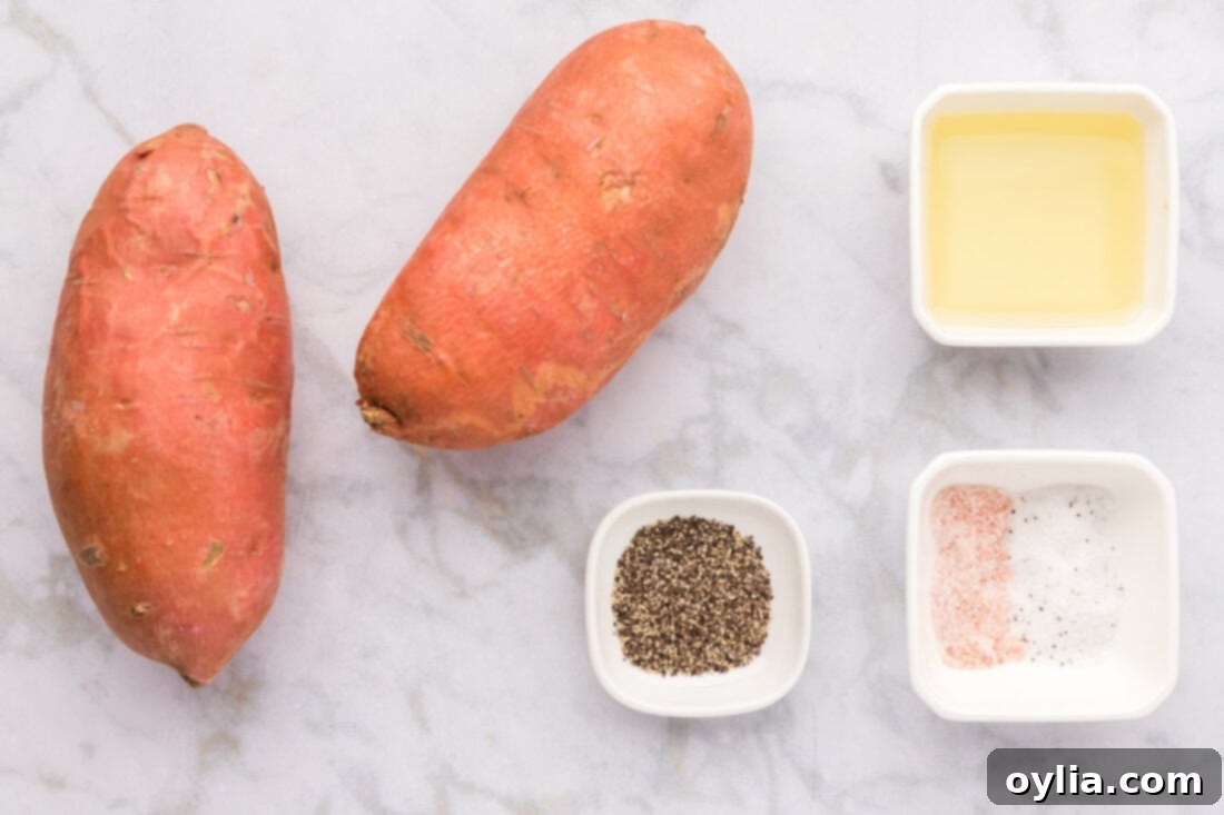 Ingredients for Air Fryer Sweet Potato Fries laid out on a cutting board, including sweet potatoes, olive oil, and seasonings.
