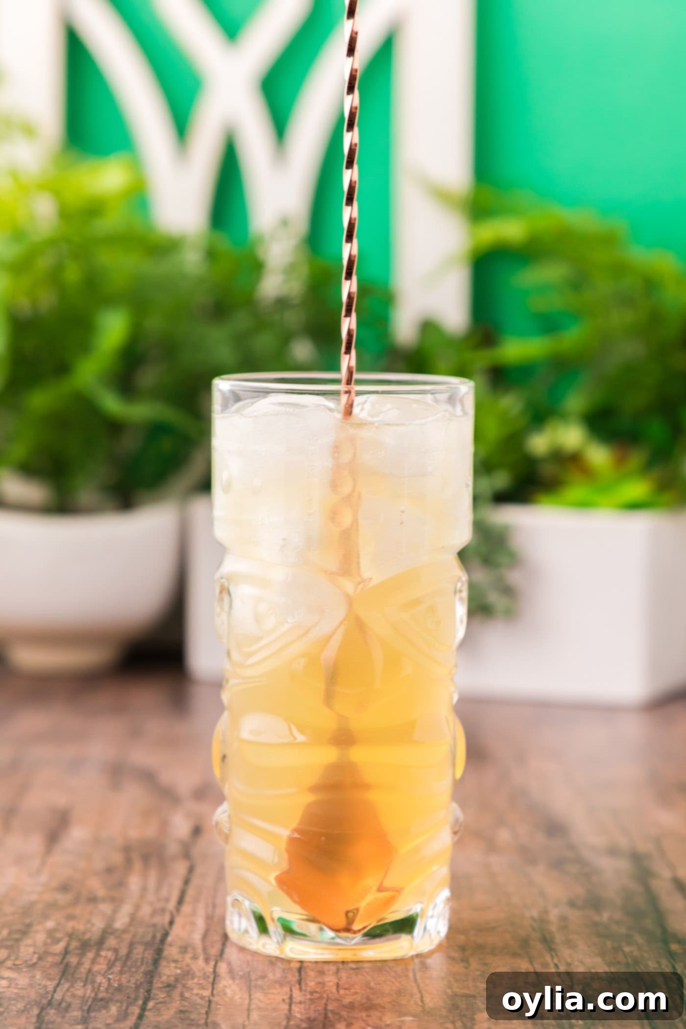 cocktail spoon stirring a refreshing Jamaican rum cocktail