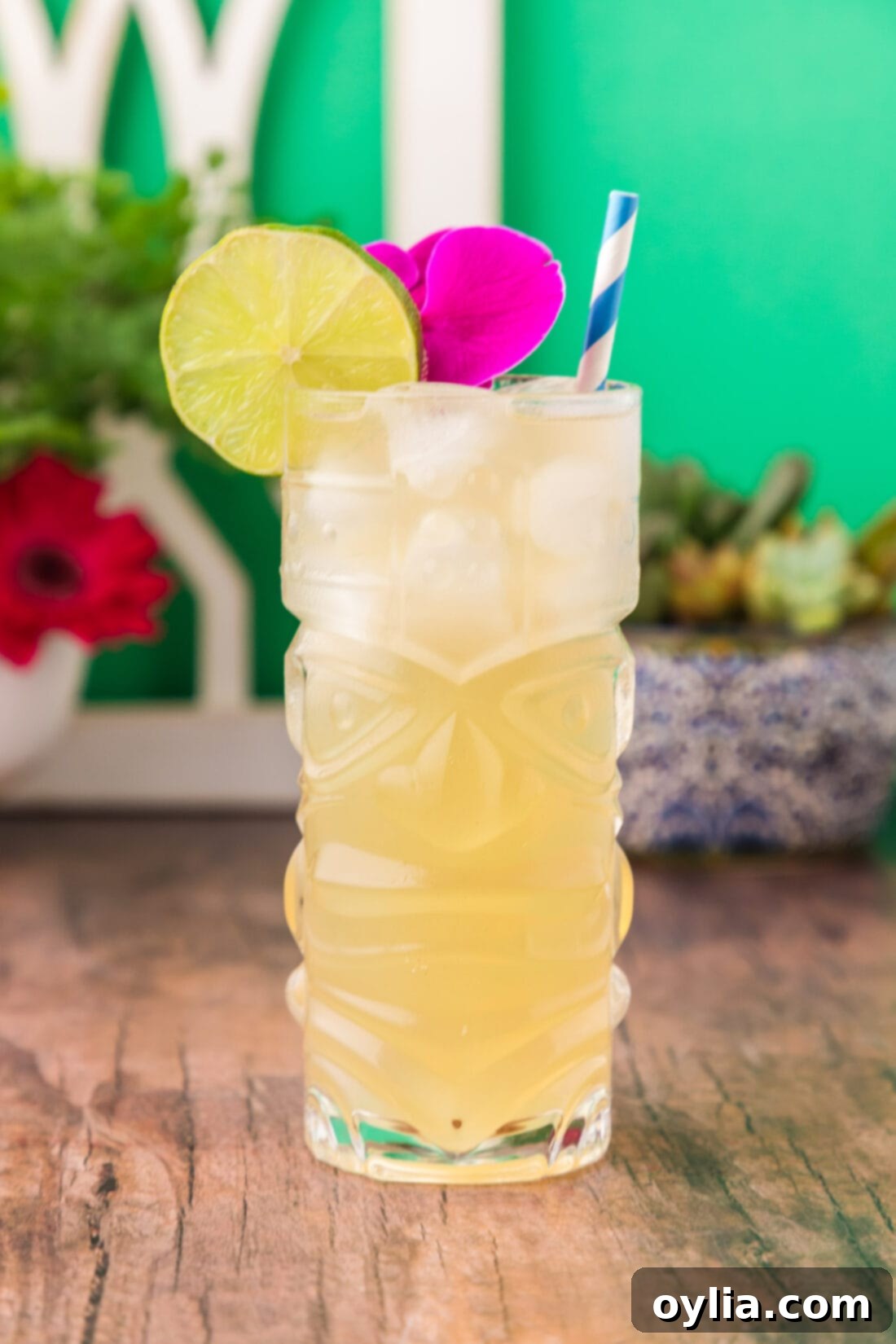 Side photo of a Jamaican Mule garnished with a lime wheel and a vibrant tropical flower, perfect for a summer drink.