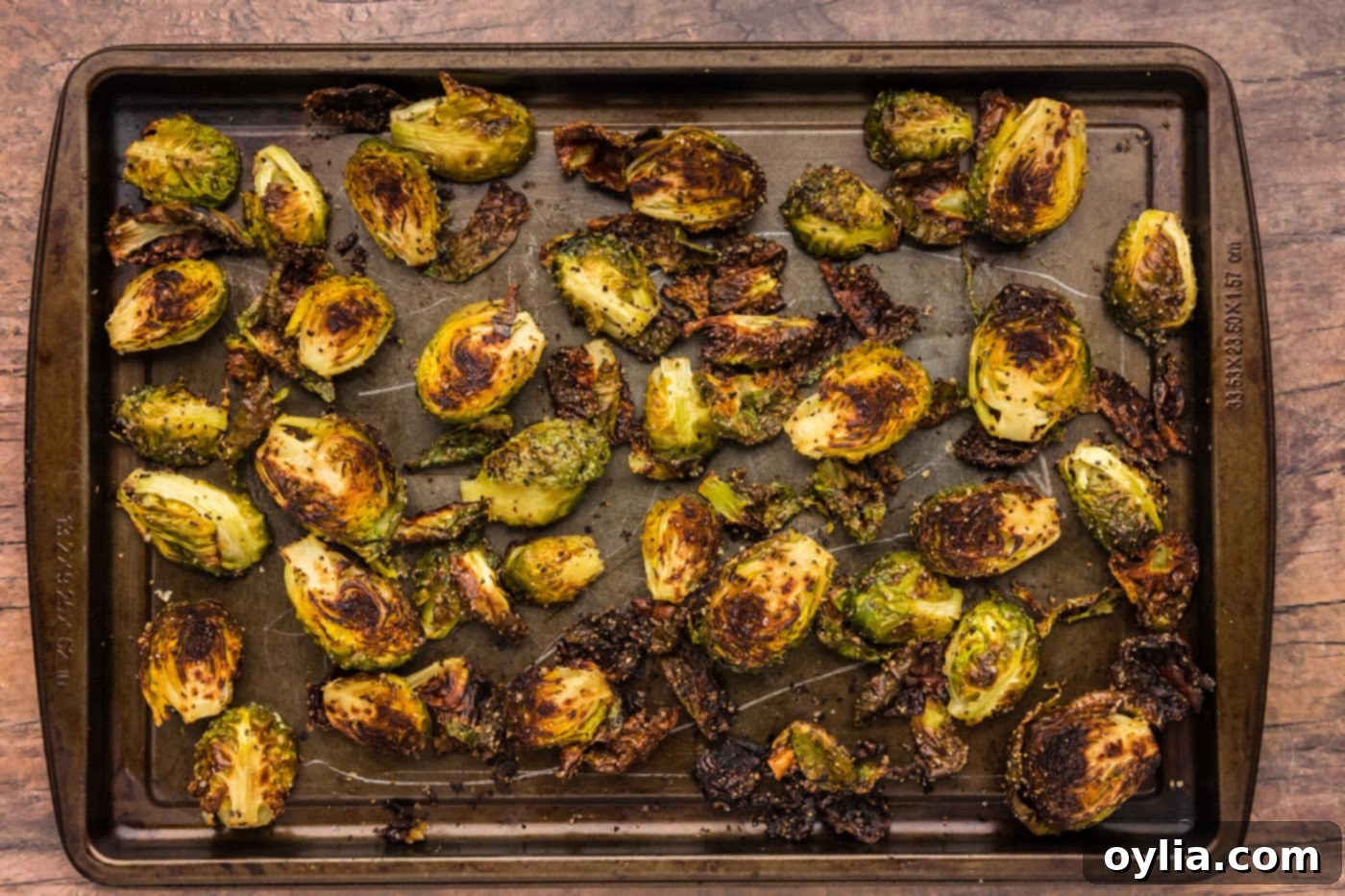 finished roasted brussels sprouts, golden brown and perfectly crispy, spread on a baking sheet