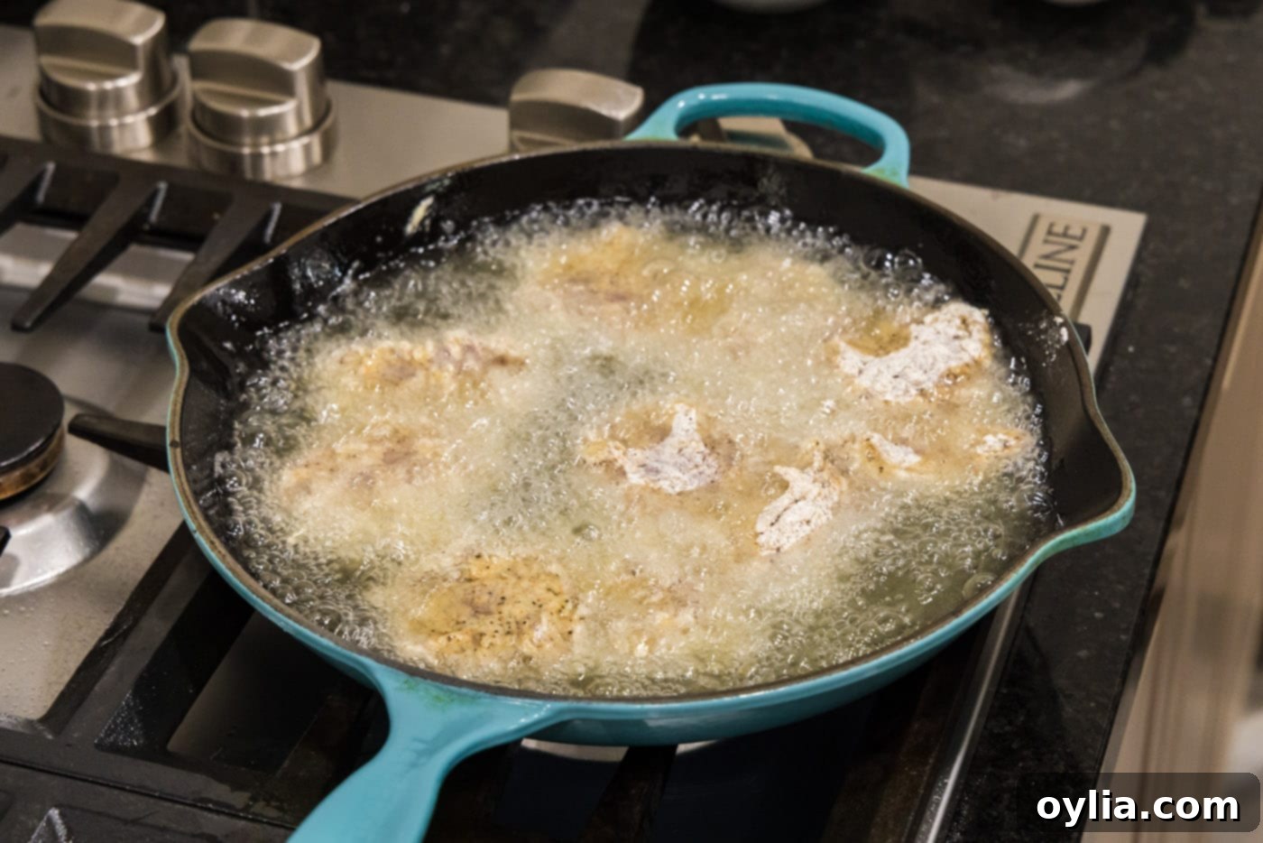 dredged chicken frying in oil