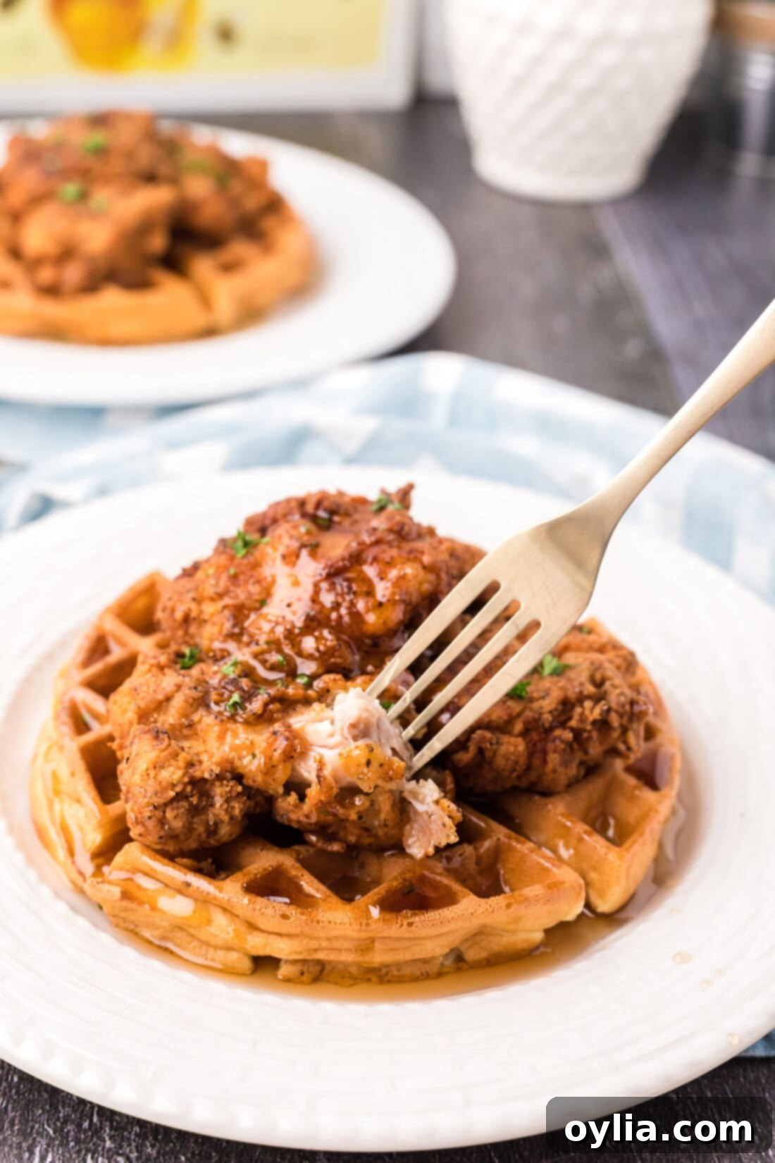 Fork taking a piece of Chicken and Waffles