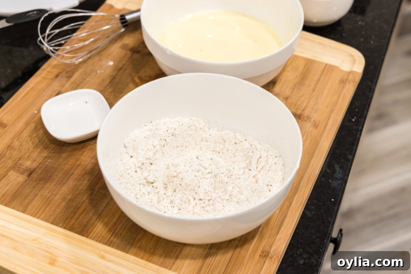 flour, cornstarch, Slap Ya Mama seasoning, garlic salt, and black pepper in a bowl