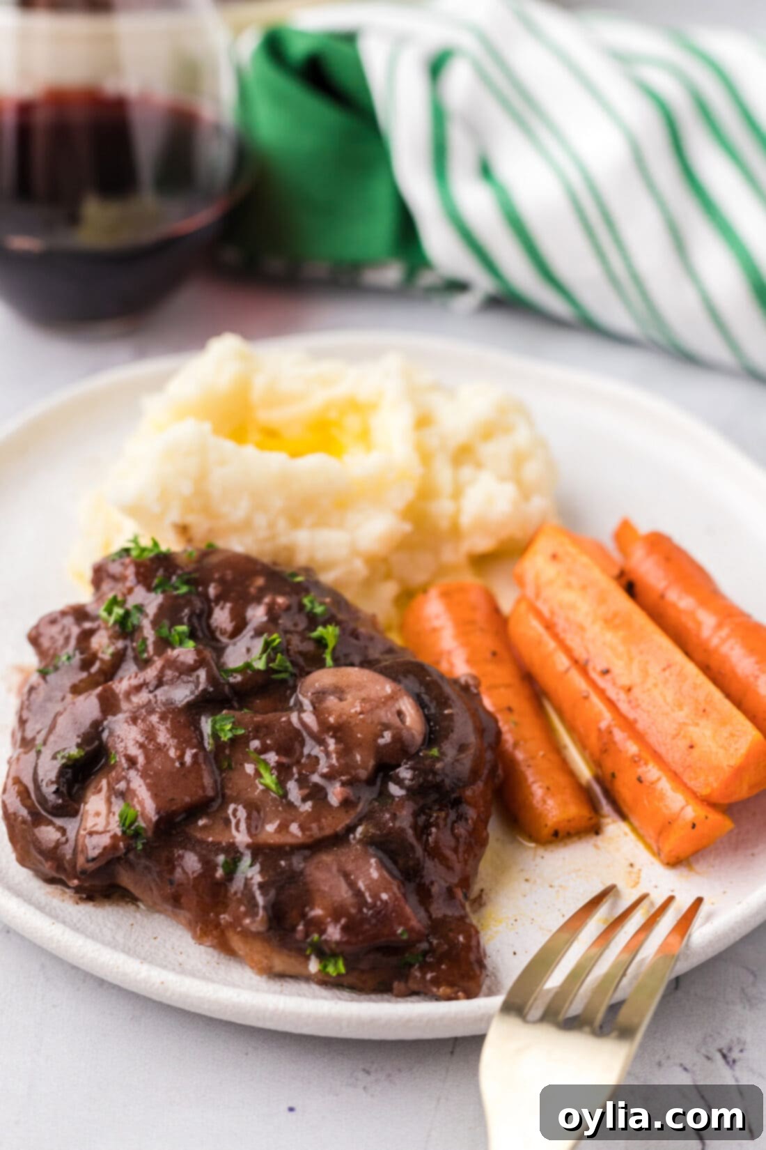 Plated Veal Marsala with mashed potatoes and carrots, ready to serve.