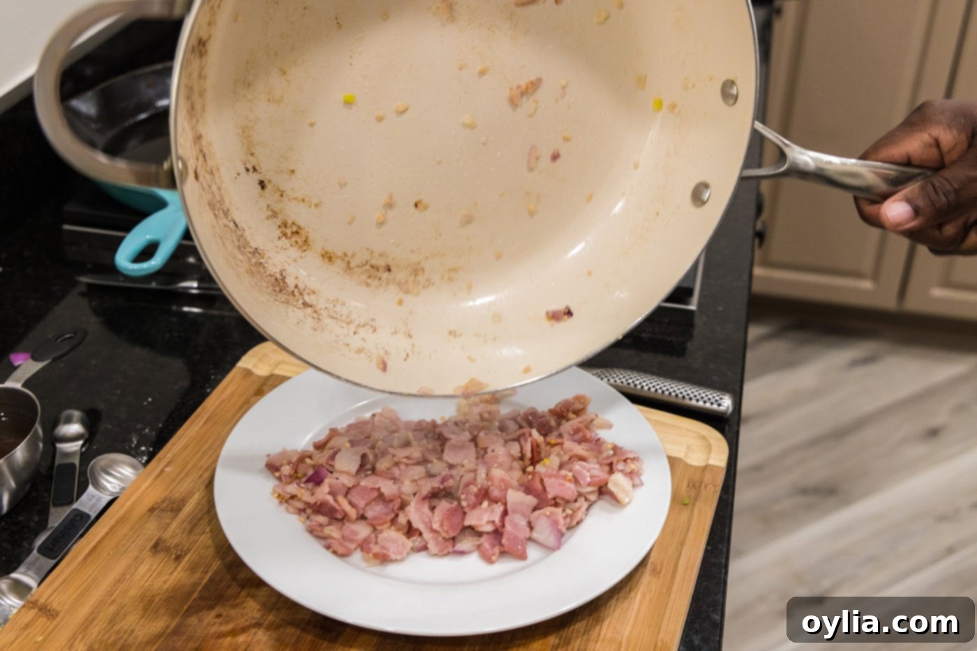 Transferring the cooked shallot and bacon mixture to a plate