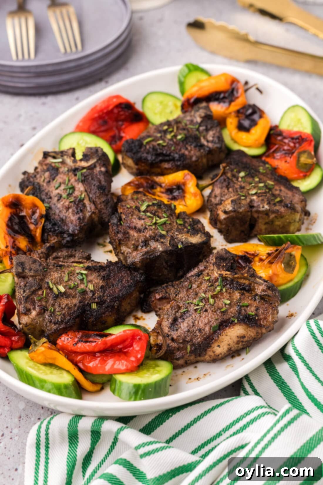 Succulent Grilled Lamb Loin Chops 2 Grilled Lamb Loin Chops on a platter with vegetables