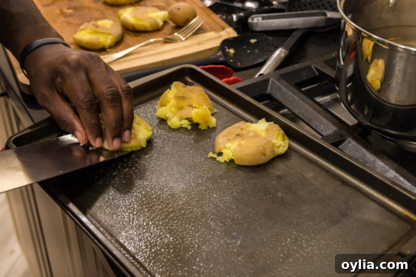 placing potatoes onto a baking sheet