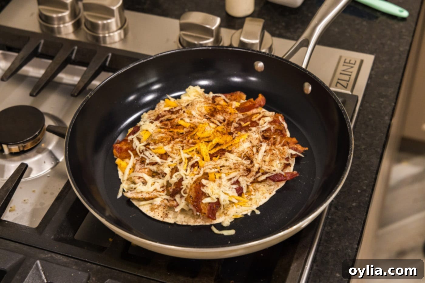 Chicken bacon ranch quesadilla cooking in a skillet
