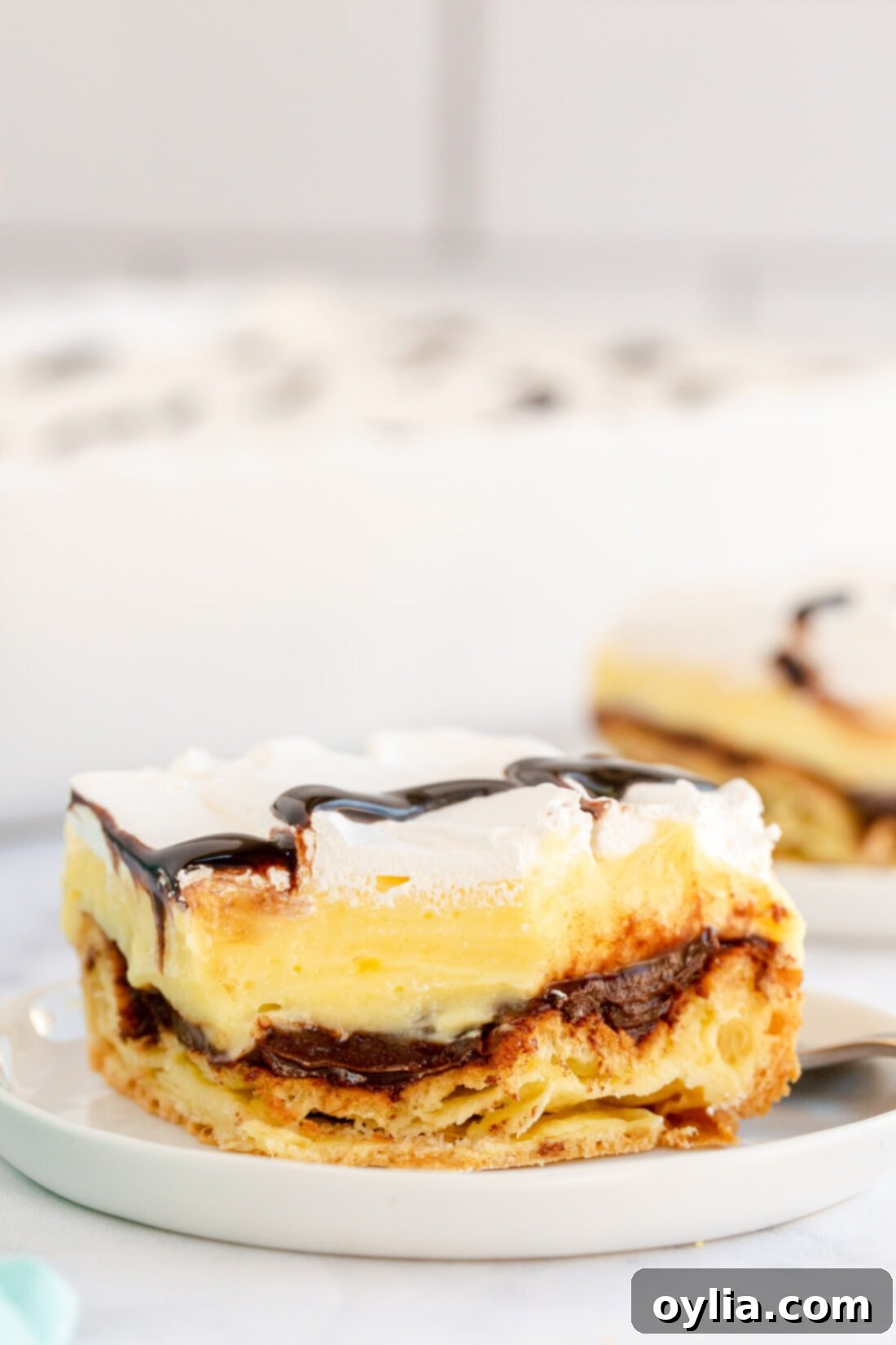 slice of Cream Puff Chocolate Eclair Cake on plate