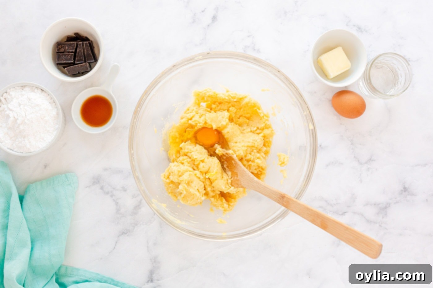 mixing dough with wooden spoon in a bowl