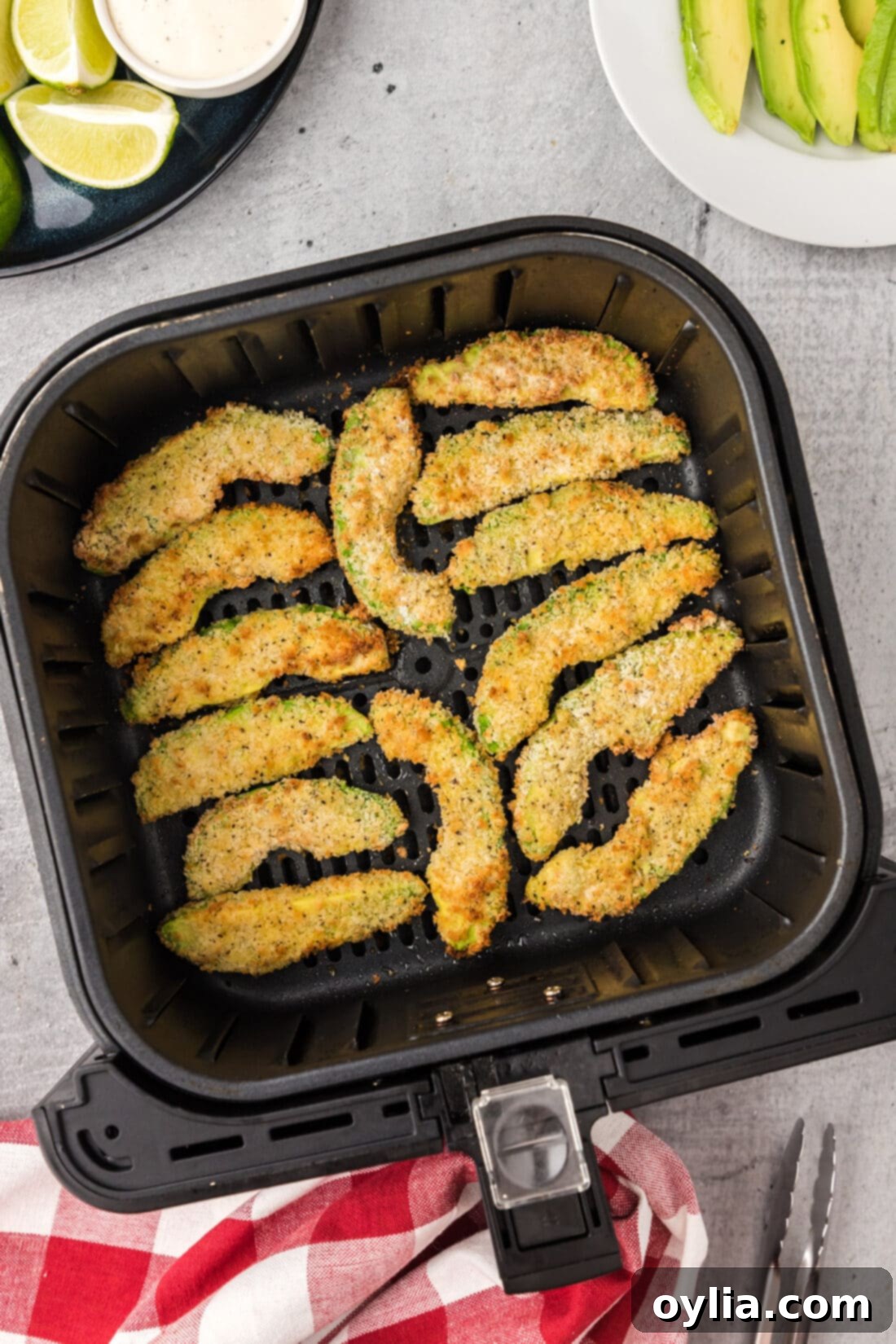 Air Fryer Avocado Fries cooking in an Air Fryer basket for perfect crispiness