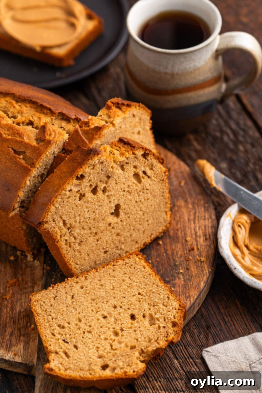 Loaf of Peanut Butter Bread cut into slices, showcasing its soft texture and golden-brown crust.