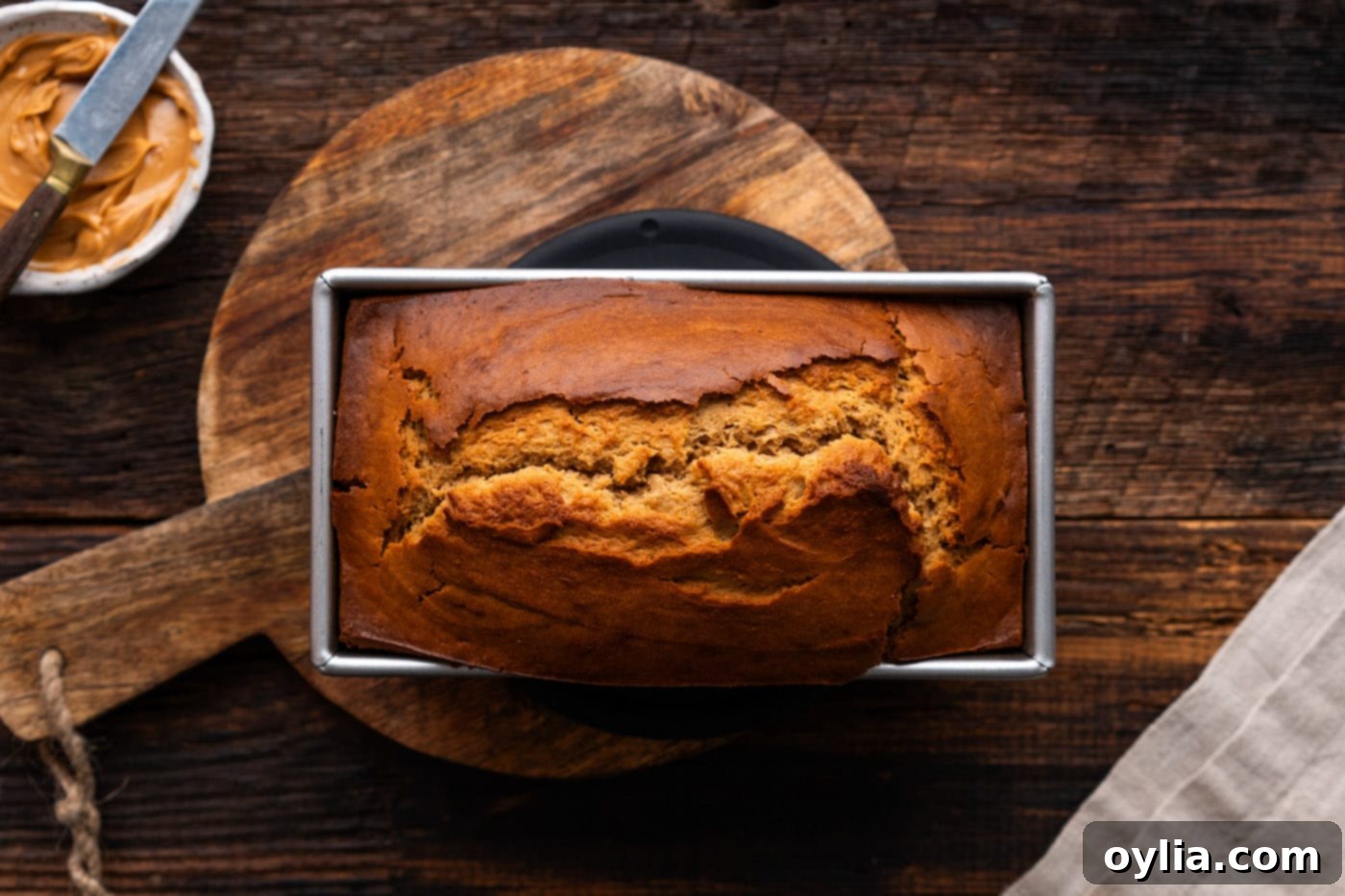 Freshly baked peanut butter bread in a loaf pan, golden brown and perfectly risen.