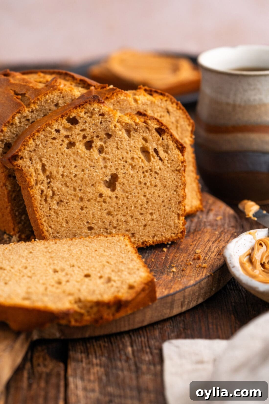 Close-up side view of a perfectly baked slice of Peanut Butter Bread, showing its tender crumb and inviting texture.