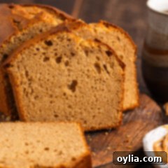Close up photo of a loaf of Peanut Butter Bread cut into slices, highlighting the soft interior texture.