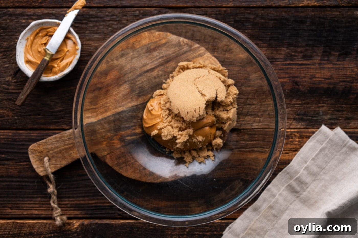 Brown sugar and creamy peanut butter in a mixing bowl before combining.