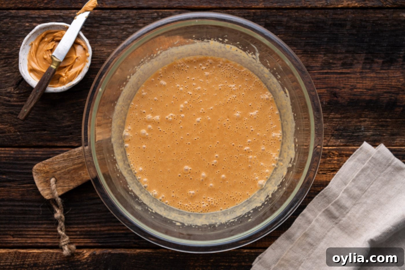 Smooth and well-combined peanut butter bread batter in a mixing bowl, ready for dry ingredients.